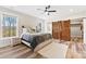 Bright bedroom featuring wood floors, accent wall, sliding barn doors, and ensuite bathroom at 40934 Deer Haven Dr, Albemarle, NC 28001