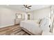Bedroom featuring hardwood floors, closet, ceiling fan, and view into the hall at 40934 Deer Haven Dr, Albemarle, NC 28001