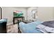 Comfortable bedroom with a mounted TV and a glimpse into the bright kitchen, offering a practical living space at 40934 Deer Haven Dr, Albemarle, NC 28001