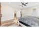 Bedroom with hardwood floors, ceiling fan, white trim, and a view into the hall at 40934 Deer Haven Dr, Albemarle, NC 28001
