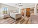 A stylish bedroom features hardwood floors, a ceiling fan, and sliding barn doors at 40934 Deer Haven Dr, Albemarle, NC 28001
