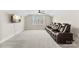 A comfortable, carpeted bonus room features an entertainment area, a ceiling fan, and ample lighting at 40934 Deer Haven Dr, Albemarle, NC 28001