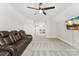 Relax in this bonus room with a comfortable leather sofa and a mounted television at 40934 Deer Haven Dr, Albemarle, NC 28001