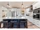 Bright kitchen featuring white cabinets, stainless steel appliances, subway tile backsplash and a large island at 40934 Deer Haven Dr, Albemarle, NC 28001