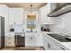 Clean kitchen with white cabinets, stainless steel appliances, subway tile backsplash, and modern fixtures at 40934 Deer Haven Dr, Albemarle, NC 28001