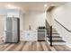 Basement kitchenette with stainless steel refrigerator, microwave, sink, and white cabinetry at 40934 Deer Haven Dr, Albemarle, NC 28001