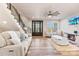 Bright living room with hardwood floors, modern fireplace, and a coffered ceiling with fan at 40934 Deer Haven Dr, Albemarle, NC 28001