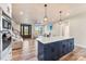 Open concept living space with large island, a coffered ceiling with fan, and hardwood floors at 40934 Deer Haven Dr, Albemarle, NC 28001