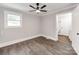 A serene bedroom with a ceiling fan offers a calming retreat with a connecting bathroom at 412 Pear St, Gastonia, NC 28054
