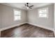 A well-lit bedroom with large windows and ceiling fan, provides an inviting retreat at 412 Pear St, Gastonia, NC 28054