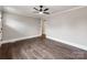 Spacious room featuring hardwood floors, a ceiling fan, and a doorway to an additional room at 412 Pear St, Gastonia, NC 28054
