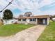 Cozy single-story house featuring a charming entrance, well-kept lawn, and a convenient carport at 412 Pear St, Gastonia, NC 28054