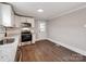 Well-lit kitchen offering stainless steel appliances, granite counters, and white cabinetry at 412 Pear St, Gastonia, NC 28054