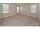 Bright bedroom featuring neutral walls, plush carpet, and windows offering natural light at 459 Olympia Way, York, SC 29745