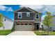 Charming two-story home featuring a two-car garage, stone accents, and well-maintained landscaping in the front yard at 459 Olympia Way, York, SC 29745