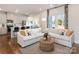 Bright living room with large windows, hardwood flooring, a comfortable couch and open to kitchen at 459 Olympia Way, York, SC 29745