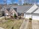 Aerial view showcases a home with a well-maintained lawn and mature trees at 4642 Willow Glen Rd, Harrisburg, NC 28075