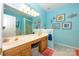 Bright bathroom with double sinks, decorative mirrors, and themed decor at 4642 Willow Glen Rd, Harrisburg, NC 28075