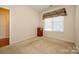 Bright bedroom featuring neutral walls, carpet flooring, and a window with natural light at 4642 Willow Glen Rd, Harrisburg, NC 28075