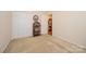 Neutral bedroom showcasing a closet, a rattan shelf, and doorway to another room at 4642 Willow Glen Rd, Harrisburg, NC 28075
