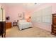 Cozy bedroom with soft pink walls, a large window, and comfortable furnishings at 4642 Willow Glen Rd, Harrisburg, NC 28075