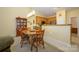 Cozy dining area with hardwood table, oak cabinetry, stainless appliances, and a casual eat-in kitchen design at 4642 Willow Glen Rd, Harrisburg, NC 28075