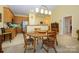 Inviting dining room featuring a classic wooden table and chairs with a view to the kitchen at 4642 Willow Glen Rd, Harrisburg, NC 28075