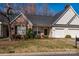 Charming brick and siding home with well-maintained lawn and two-car garage at 4642 Willow Glen Rd, Harrisburg, NC 28075
