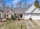 Charming single-story home with a brick facade, well-manicured lawn, and a two-car garage at 4642 Willow Glen Rd, Harrisburg, NC 28075