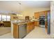 Kitchen view showcasing the sink, stainless steel appliances, and view to the living room at 4642 Willow Glen Rd, Harrisburg, NC 28075