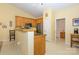 Bright kitchen with stainless steel refrigerator, wooden cabinets, and an adjacent doorway at 4642 Willow Glen Rd, Harrisburg, NC 28075