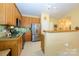 Well-lit kitchen featuring stainless steel appliances, wooden cabinetry, and a practical layout at 4642 Willow Glen Rd, Harrisburg, NC 28075