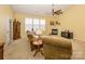 Cozy living room with high ceilings, a ceiling fan, a fireplace, large windows, and comfortable seating at 4642 Willow Glen Rd, Harrisburg, NC 28075