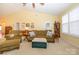 Spacious living room featuring vaulted ceilings, comfortable furniture, a ceiling fan, and natural light at 4642 Willow Glen Rd, Harrisburg, NC 28075