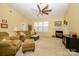 Inviting living room with vaulted ceilings, a fireplace, a ceiling fan, and plush furniture arrangement at 4642 Willow Glen Rd, Harrisburg, NC 28075