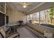 Cozy screened patio perfect for relaxing, featuring outdoor furniture and grill at 4642 Willow Glen Rd, Harrisburg, NC 28075