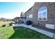 Brick home featuring a cozy backyard patio with outdoor seating and a grill, perfect for entertaining at 4812 Campobello Dr, Monroe, NC 28110
