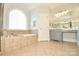 Bright bathroom featuring a soaking tub, glass shower, and gray vanity at 4812 Campobello Dr, Monroe, NC 28110