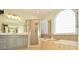 Bright bathroom featuring a soaking tub, glass shower, and neutral tile at 4812 Campobello Dr, Monroe, NC 28110