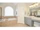 Bathroom features soaking tub, a large glass block window, and a double vanity at 4812 Campobello Dr, Monroe, NC 28110