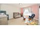 Bright Bedroom with pink walls, cozy rocking chair, and a cute crib at 4812 Campobello Dr, Monroe, NC 28110