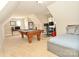 Spacious bonus room featuring a pool table, computer area and a comfortable daybed for relaxation at 4812 Campobello Dr, Monroe, NC 28110