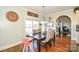 Bright dining room features hardwood floors, a modern chandelier and an archway leading to the living area at 4812 Campobello Dr, Monroe, NC 28110