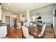 Open-concept dining area flowing to a kitchen with stainless steel appliances and a cozy living room with a fireplace at 4812 Campobello Dr, Monroe, NC 28110