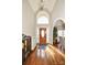 Grand foyer with soaring ceilings, hardwood floors, and arched window and doorway at 4812 Campobello Dr, Monroe, NC 28110