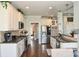 Bright kitchen featuring stainless appliances, granite counters, and white cabinetry at 4812 Campobello Dr, Monroe, NC 28110