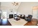 Bright living room featuring a fireplace, hardwood floors, and leather seating at 4812 Campobello Dr, Monroe, NC 28110