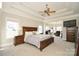Spacious bedroom with tray ceiling, fan, and sitting area with lots of natural light at 4812 Campobello Dr, Monroe, NC 28110