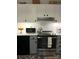 Well-equipped kitchen with stainless steel appliances, white cabinets, and bright countertops at 5702 Burning Ridge Dr, Monroe, NC 28110