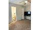 This living room has neutral walls, carpet flooring and ceiling fan and a TV at 5702 Burning Ridge Dr, Monroe, NC 28110